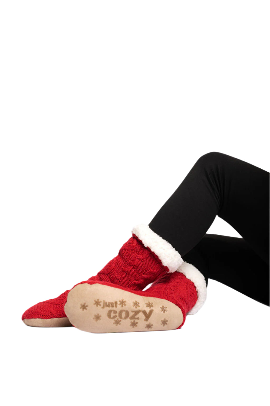 A pair of red knitted slipper socks with a cozy sherpa lining, featuring non-slip gripper bottoms.